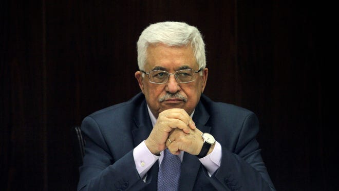 Palestinian President Mahmoud Abbas chairs a session of the Palestinian cabinet in the West Bank city of Ramallah, July 28, 2013. U.S. Secretary of State John Kerry shuttled between Israeli and Palestinian leaders for months seeking a breakthrough and announced last week that the Palestinians and the Israelis were willing to meet to discuss renewing talks. The Palestinians long refused to return to the negotiating table unless Israel agreed to several preconditions.
