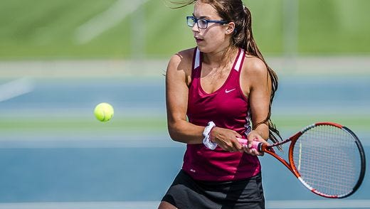 Sydni Greenhoe of Portland lines up a forehand during her #3 singles finals match with Grace Mohr of Lansing Catholic last season. Greenhoe is one of several returning starters for the Raiders in 2016.