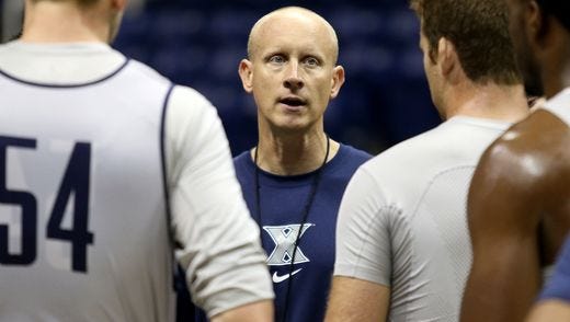 Chris Mack (center) and his wife, Christi, are holding basketball clinics Sunday at St. Henry in Florence to benefit a school chaperone injured by falling debris in Covington. Proceeds will go to Valerie's Prayer Angel Fund for the family of Valerie McNamara.