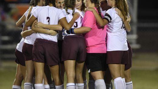 Henderson County players huddle up before the start of the game against Hopkinsville during the girls Second Region championship.