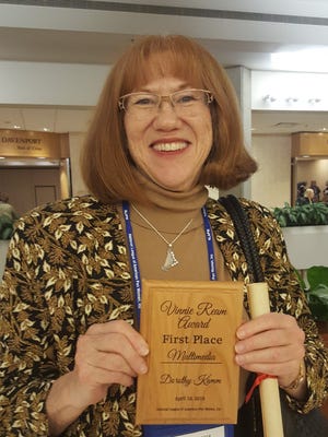 Dorothy Kamm displays the sterling silver harp pendant and plaque she received for her first place award in the Arts and Letters Multi-Media category of the Vinnie Ream Medal Competition sponsored by the National League of American Pen Women.