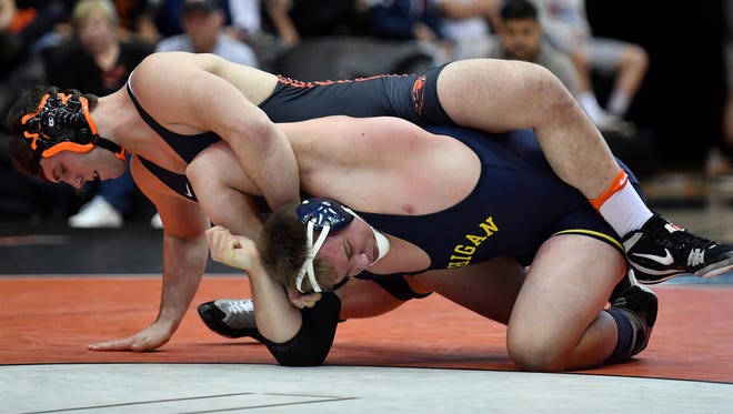 Oregon State's Cody Crawford (top) competes in a match against Michigan earlier this season.