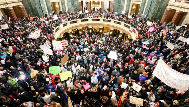 Thousands of Latinos, immigrants and their supporters congregate inside the Wisconsin State Capitol in Madison, Wis. to protest legislative bills they believe to be anti-immigration Thursday, Feb. 18, 2016. (John Hart /Wisconsin State Journal via AP) MANDATORY CREDIT 