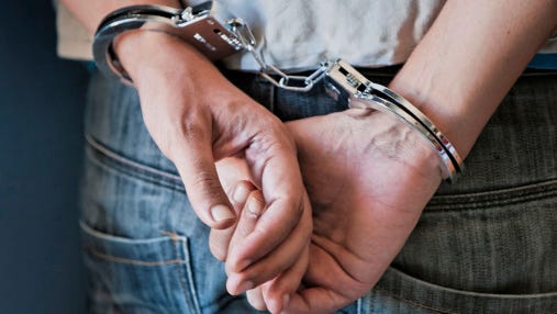 Young man in handcuffs