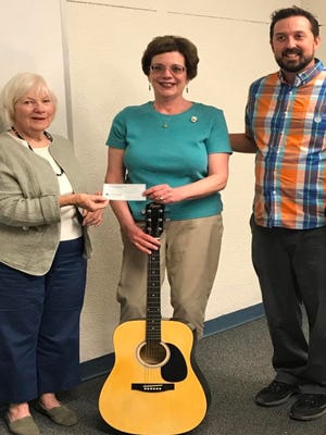 The Friends of Thomas Branigan Memorial Library are supporting a new, free summer program for teens to learn to play the guitar at the Branigan Library with the purchase of six guitars available for loan to participants who are unable to bring guitars to the classes. When the General Federation of Women's Clubs Progress Club of Las Cruces made a donation of $100, GFWC President Jean Frizzell additionally donated a guitar. The guitar classes will be offered on the second and fourth Saturdays of the month beginning June 10 from 1 to 2 pm. Teens may register at the library's Young Adult desk. From left is Branigan Friends Treasurer Bonnie Poloner, GFWC Progress Club President Jean Frizzell and library assistantguitar instructor Ryan Roy.