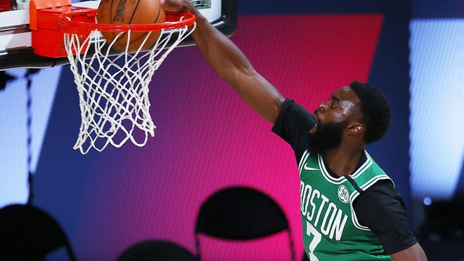 The Celtics' Jaylen Brown dunks the ball during a game against the Portland Trail Blazers on Aug. 2. Besides speaking out against social injustice, Brown has also talked about mental-health issues.