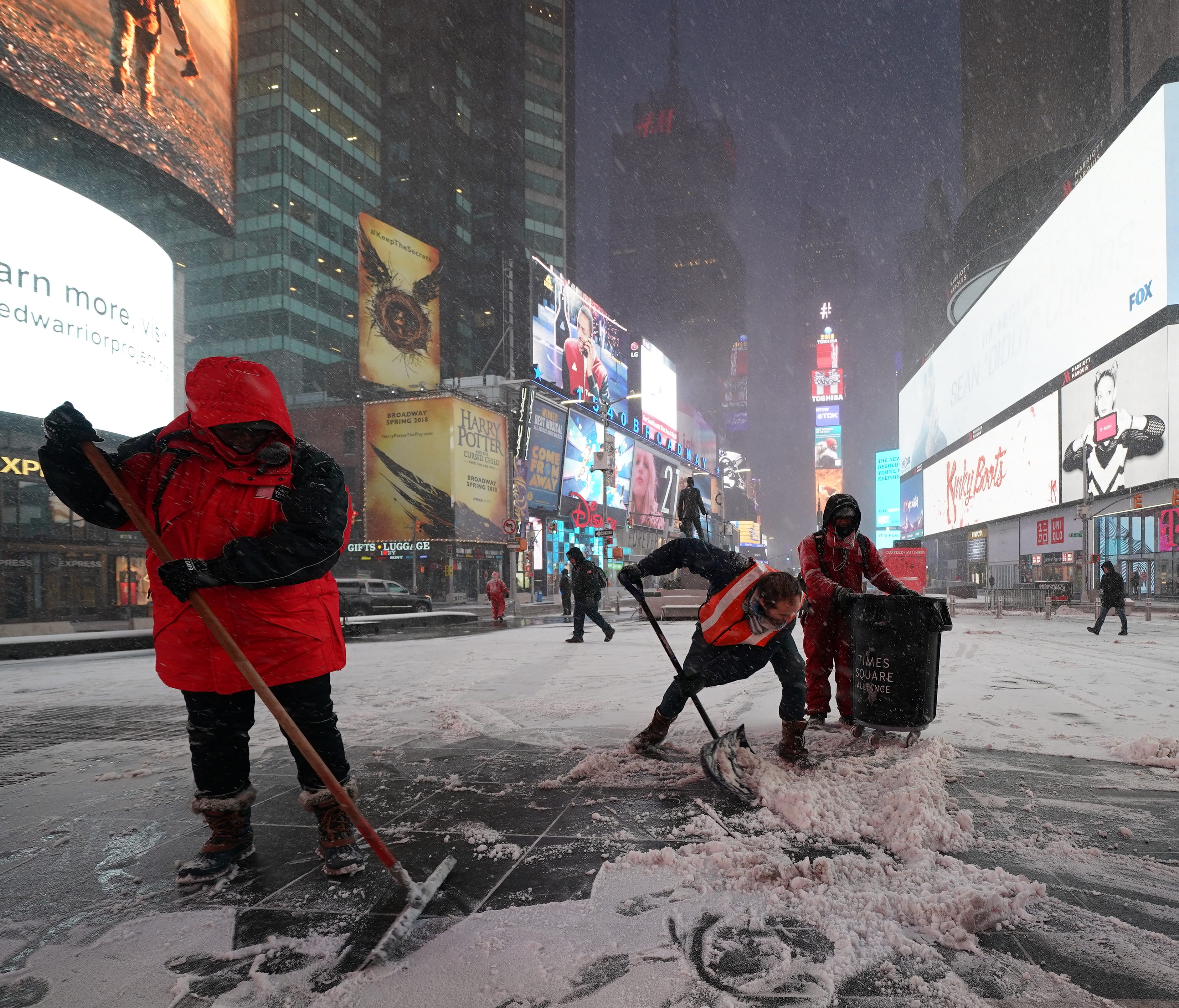 Workers clear the early snow from Times Square  in New York City, Jan. 4, 2018.