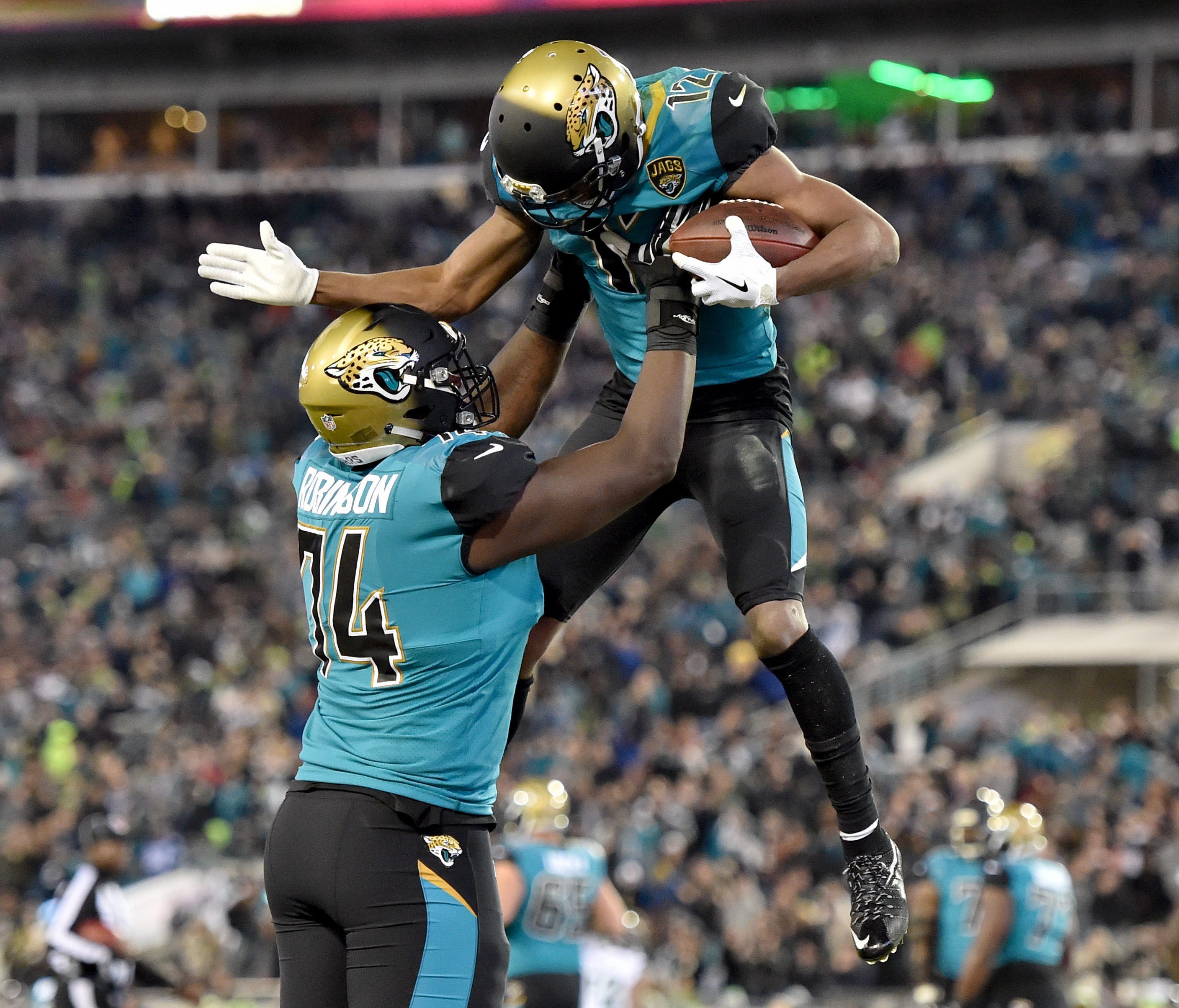 Jaguars wide receiver Dede Westbrook (right) celebrates with  offensive tackle Cam Robinson (left) after scoring a touchdown against the Seattle Seahawks during the second half at EverBank Field.