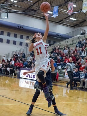 Marshall's Taryn Long (11) goes to the hoop during first half action in regional finals on Thursday.