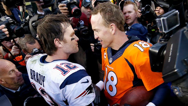 New England Patriots quarterback Tom Brady, left,  and Denver Broncos quarterback Peyton Manning speak to one another after Sunday's AFC title game. The Broncos defeated the Patriots 20-18 to advance to the Super Bowl.
