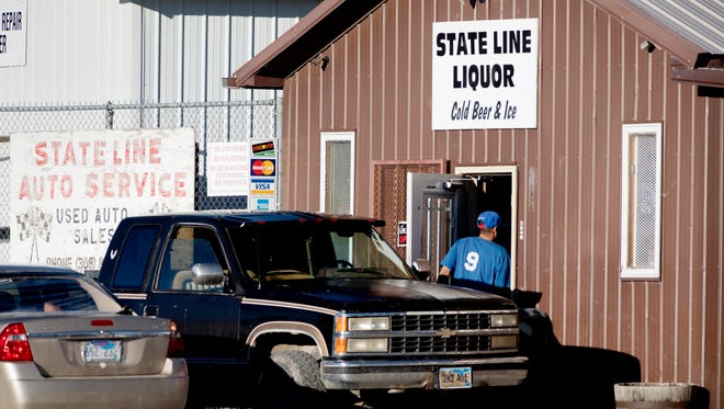 In this Oct. 21, 2016, file photo, a customer enters State Line Liquor, one of four beer stores in the town of Whiteclay, Neb. Owners of the four beer stores that sell millions of cans of beer each year near a South Dakota American Indian reservation that is plagued by alcohol-related problems, are appealing a state regulator's decision not to renew their liquor licenses. The appeal was filed late Monday, April 24, 2017, in Lancaster County District Court.