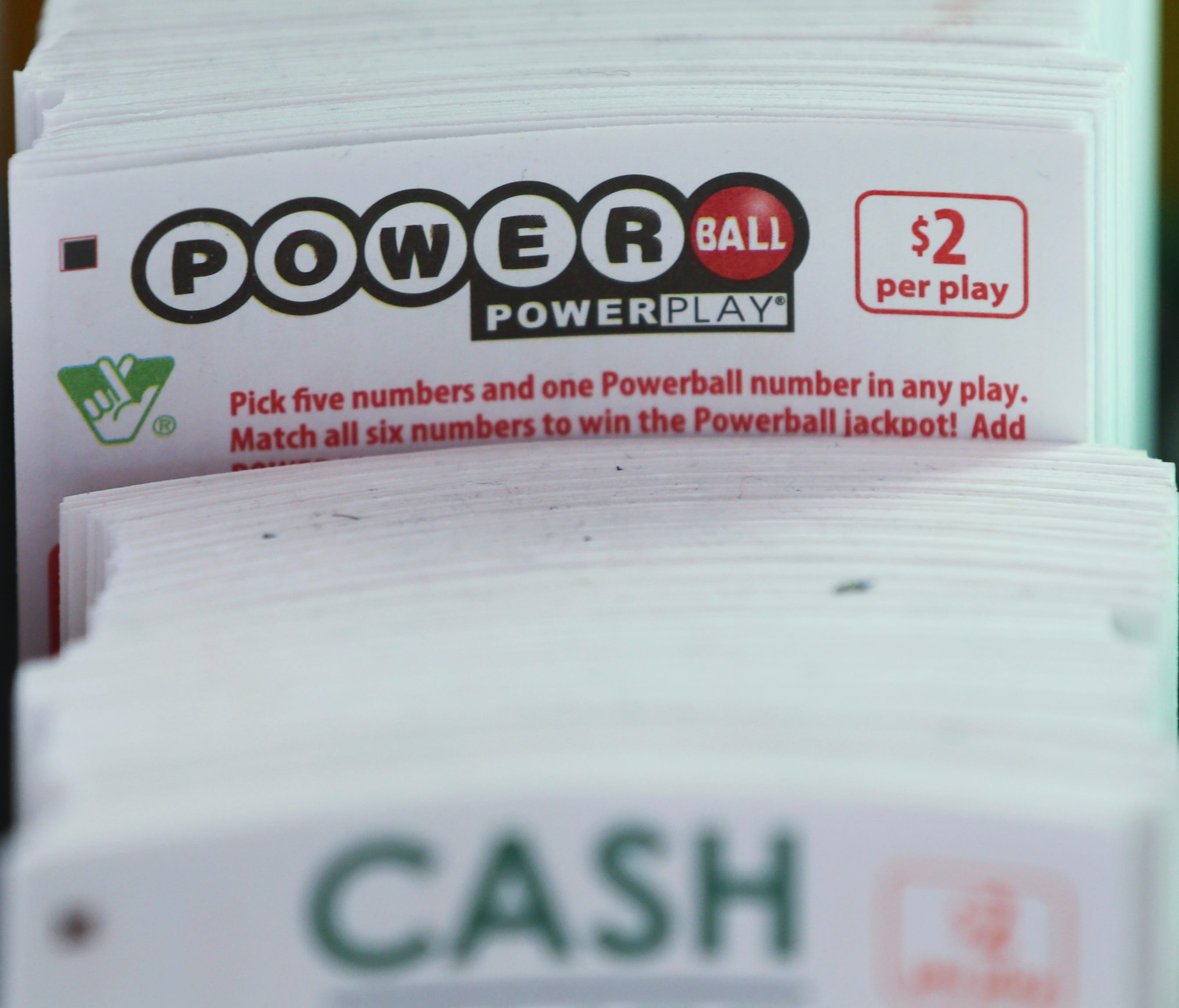 Powerball play slips are stacked up in a store Jan. 5, 2016, in Richmond, Va.