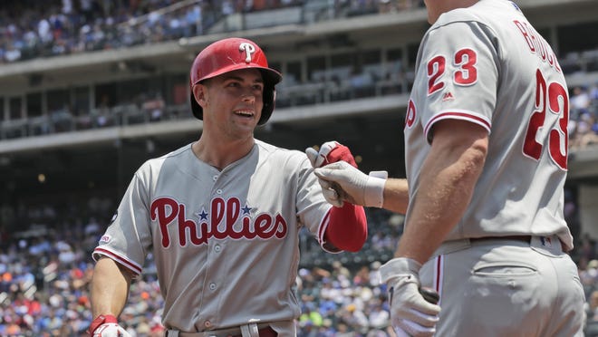 The Phillies' Scott Kingery, left, is congratulated by teammate Jay Bruce after scoring a run.