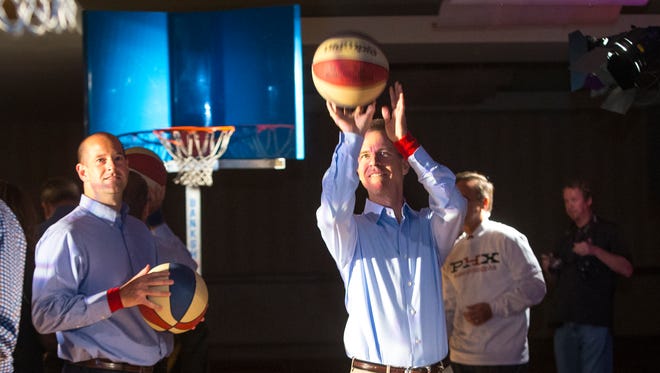 Dan Gavitt, NCAA Vice President of Men's Basketball Championships, takes a shot as he and others on the NCAA Final Four host committee play a quick game of hoops as part of their tour of Phoenix, named one of eight finalists for the tournament in 2017, 2019 or 2020. The committee will announce its decision in November.