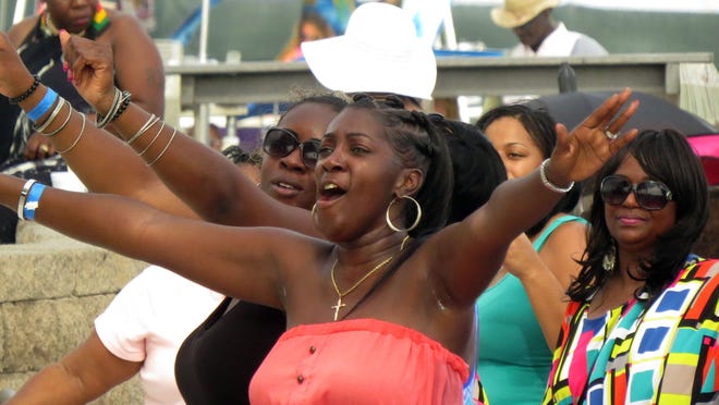 Fans get into the music of recording artist Tucka Saturday afternoon during Gulf Coast Summer Fest on Casino Beach.