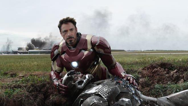 Tony Stark (Robert Downey Jr.) protects a downed War Machine (Don Cheadle) in 'Captain America: Civil War.'