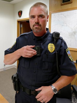 Lt. Joe Schuster of the Omro Police Department sets his body camera to record. Green Bay is considering adding body cameras to its police force.