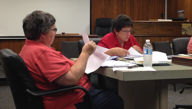 Town board members Patty Fitzgerald  and Sue Messina look over budget numbers during a work session late last month.