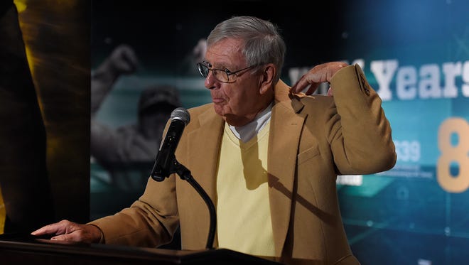 Former Green Bay Packers general manager Ron Wolf pats himself on his back as he talks about his accomplishments during a ribbon cutting ceremony for his new exhibit in his honor at the Packers Hall of Fame inside the Lambeau Field Atrium on Friday, Nov. 13, 2015. 