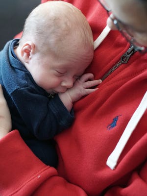 Jack Lovell is held by his mom Kristi at their home.