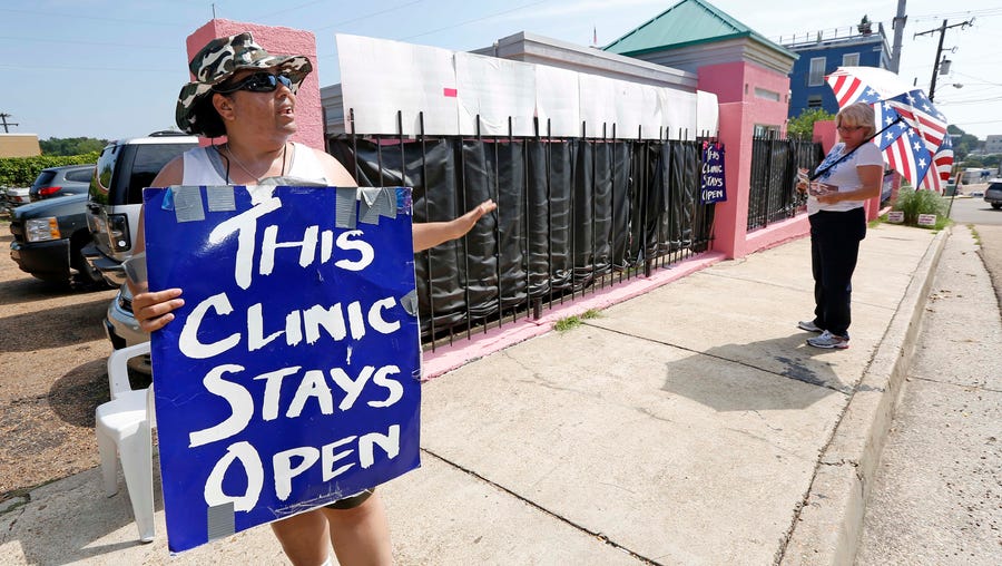 Abortion rights advocates  and opponents square off outside Mississippi's lone abortion clinic in 2013.