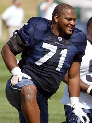 FILE - In this Aug. 15, 2006, file photo, Seattle Seahawks offensive tackle Walter Jones smiles along the sidelines during NFL football training camp at Eastern Washington University in Cheney, Wash. Jones was inducted into the Pro Football Hall of Fame in Canton on Aug. 2, 2014.