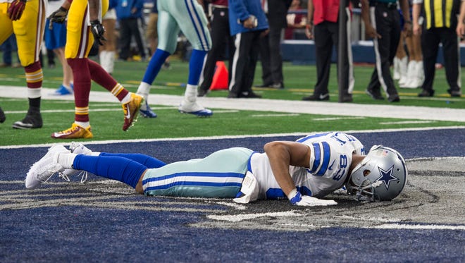 Dallas Cowboys wide receiver Terrance Williams (83) lies face down in the end zone during the second half against the Washington Redskins at AT&T Stadium. The Redskins defeat the Cowboys 34-23.