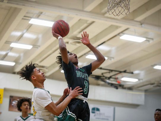 Des Moines North junior point guard Tyreke Locure runs