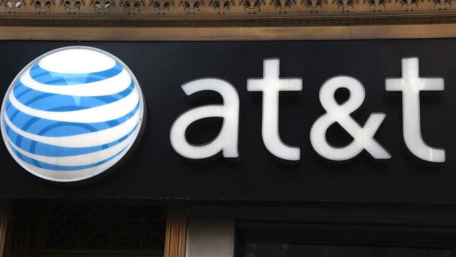 This May 6, 2012, file photo, shows an AT&T sign at a store in New York.