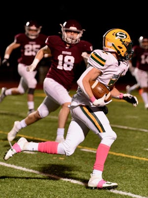 Salina South senior Jackson Hayes (7) runs with the ball while being chased by Salina Central's Brooks Burgoon (18) during Friday's game at Salina Stadium.
