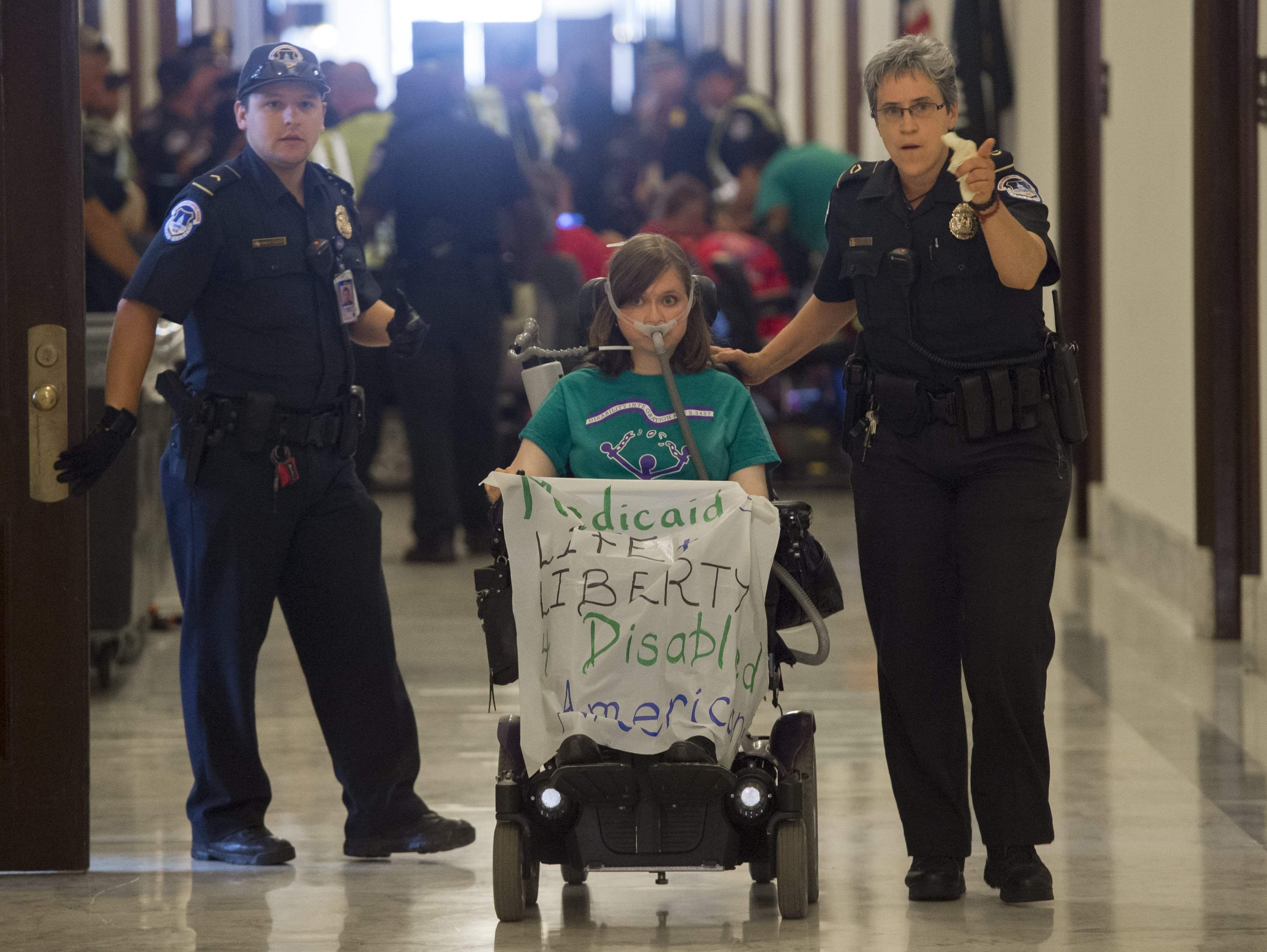 U.S. Capitol Police arrest a health care protester outside the office of Senate Majority Leader Mitch McConnell on June 22, 2017.