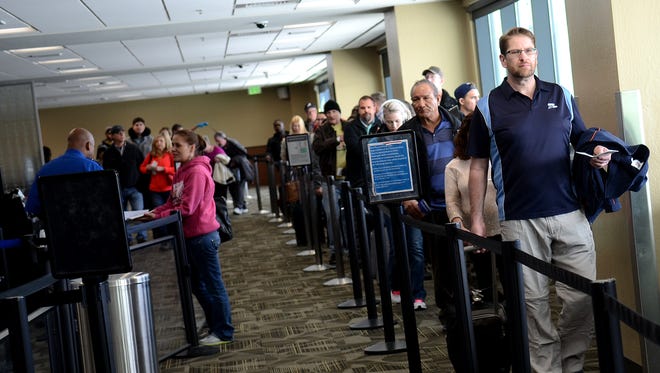 A long line of travelers wait to pass through security checkpoint on Tuesday at the Reno-Tahoe International Airport.
