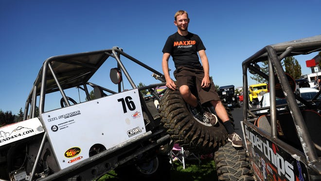 Jesse Haines poses with two "rock crawlers," one of which he built, in the Summit Racing parking lot in Sparks on Sept. 19, 2015.