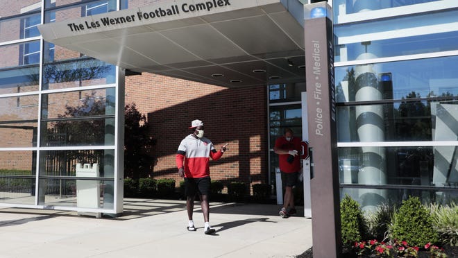 An Ohio State Buckeyes football staff member leaves voluntary workouts on Monday, June 8, 2020 at the Woody Hayes Athletic Center in Columbus, Ohio. Due to the ongoing COVID-19 pandemic, players are socially distanced during workouts and only arrive and leave in small groups.