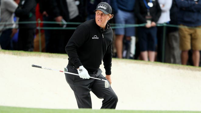 Phil Mickelson runs out of a bunker on the first hole during the first round of the 2017 Masters Tournament at Augusta National Golf Club on April 6, 2017.
