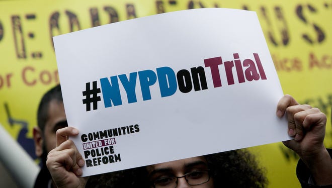 A woman holds a sign during a rally against the city's "stop and frisk" searches in lower Manhattan near federal court on March 18, 2013.