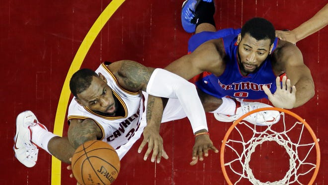 Cleveland Cavaliers' LeBron James, left, shoots against Detroit Pistons' Andre Drummond in the first half of an NBA basketball game Monday, April 13, 2015, in Cleveland.