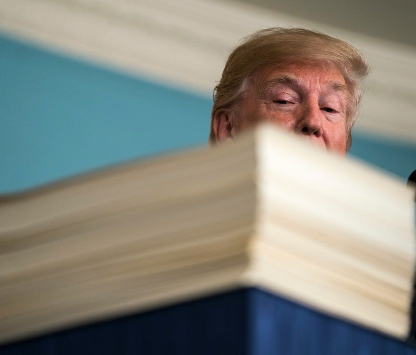 President Trump with the 2,232-page, $1.3 trillion spending bill he signed, March 23, 2018, Washington, D.C.