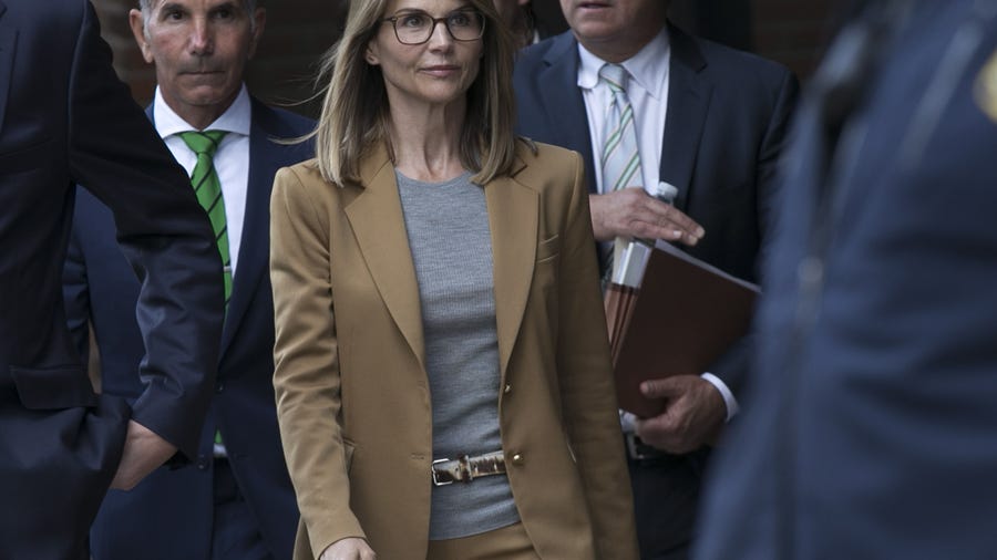 Lori Loughlin (C) and her husband Mossimo Giannulli (L) leave the John J Moakley Federal Court House after facing charges in a nationwide college admissions cheating scheme in Boston. (Photo: Katherine Taylor, EPA-EFE)