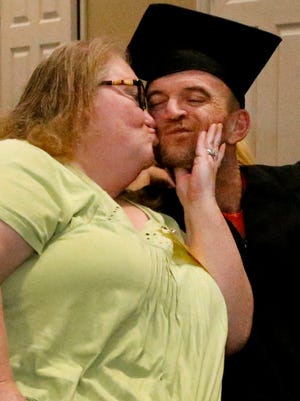 Donna Underwood kisses her son Charles Estes, a Rutherford County inmate, on the cheek, during a graduation ceremony after Estes passed the HiSET exam, earning him a high school equivalency diploma at a graduation ceremony on Nov. 30, 2017, at the Rutherford County Adult Detention Center. 