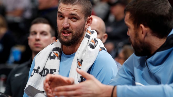 Memphis Grizzlies forward Chandler Parsons, left, confers with center Marc Gasol, of Spain, as they sit on the bench during a time out against the Denver Nuggets in the first half of an NBA basketball game Friday, Nov. 24, 2017, in Denver. (AP Photo/David Zalubowski)
