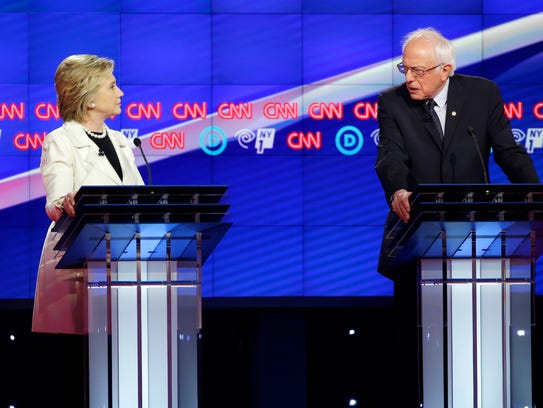 Hillary Clinton and Bernie Sanders take part in a debate