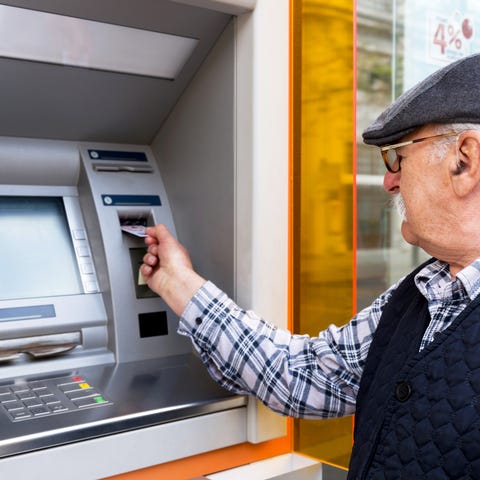 A senior man at an ATM.
