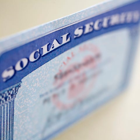 A Social Security card standing up on a table,...