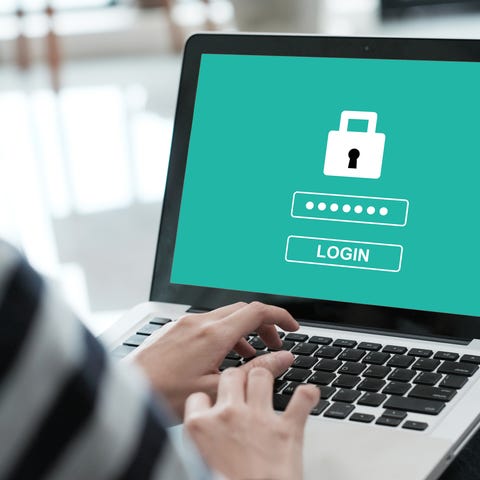 A person entering a password on a laptop