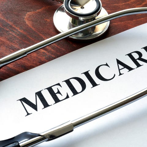 Paper titled "Medicare" with a stethoscope, both...