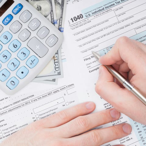 Person filling out tax forms.