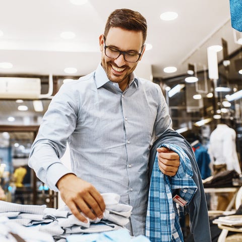A man shopping for clothes in a store.