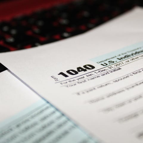 Tax Form 1040 on computer keyboard