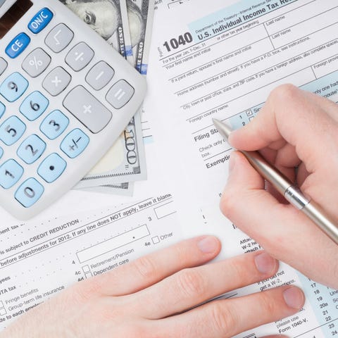 Person filling out tax forms.